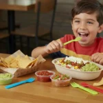 Smiling child with Chipotle kids meal and juice box