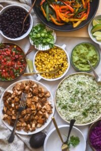 Chipotle  chipotle menu  with price burrito  bowl, tacos, chips with guacamole, and drink on a wooden table